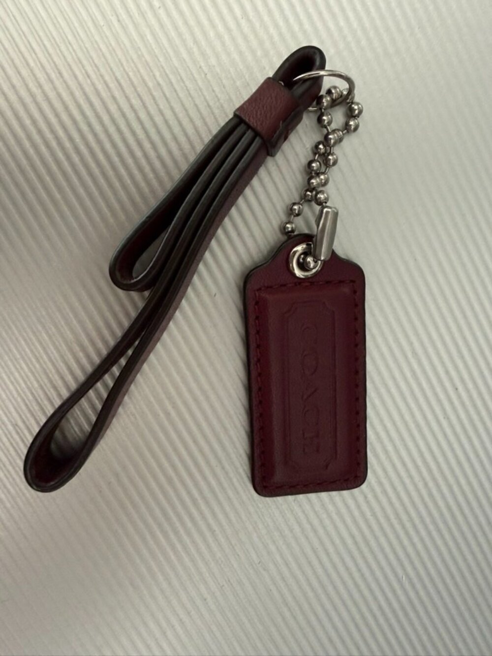 Coach tag with leather loop